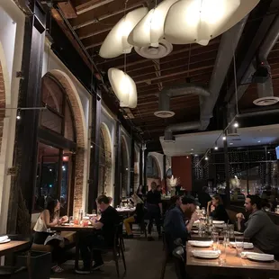people sitting at tables in a restaurant