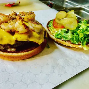 two burgers with shrimp and lettuce