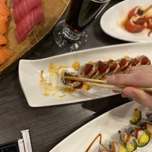 a person eating sushi with chopsticks