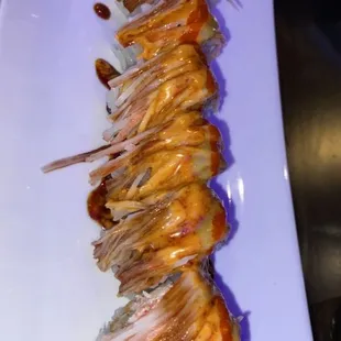 a long row of shrimp on a white plate