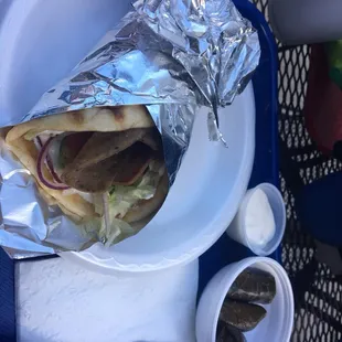 Gyro pita at lunch with grape leaves. Homemade tzatziki sauce !