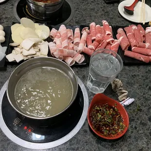 Bone broth hot pot, lamb, pork belly, beef, potato slices, mushrooms, quail eggs, squid