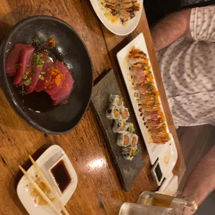 a wooden table with plates of food