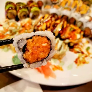 a plate of sushi and rolls