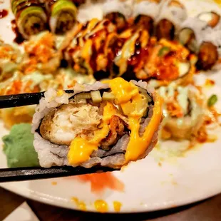 a plate of sushi and rolls