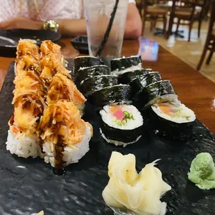 a plate of sushi and chopsticks