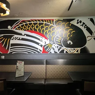 a large fish mural on the wall