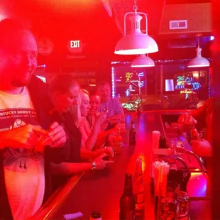 a group of people sitting at a bar
