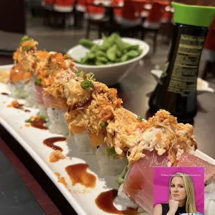 a sushi roll with a side of salad