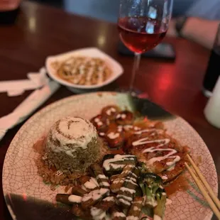 a plate of food and a glass of wine