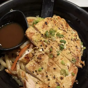 Yaki-soba stir fry udon noodle entree with Chicken as selected protein.