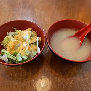 two bowls of soup and a spoon