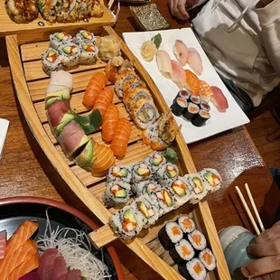 a long row boat filled with sushi