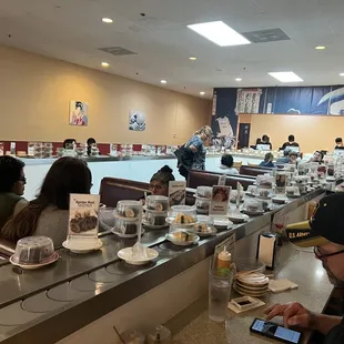 people sitting at the counter in a restaurant
