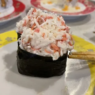 a sushi roll on a plate with chopsticks