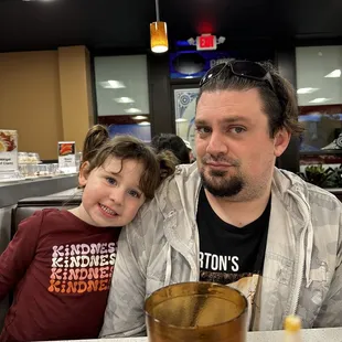 a man and a child at a fast food restaurant