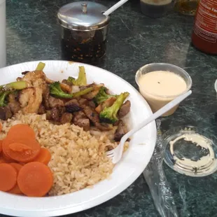 a plate of rice, carrots, and meat