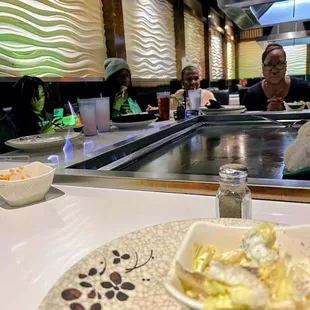 Grill being prepared for rice, shrimp,  Grill being prepared for rice , steak , shrimp  and mixed vegetables )...