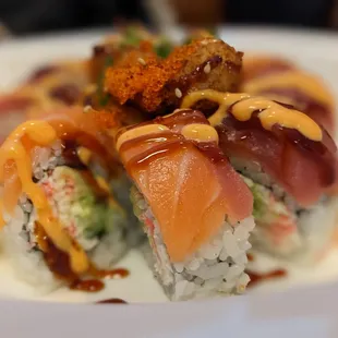 Rainbow Blossom Roll around $18. Salmon and tuna with fried mini scallops on top.