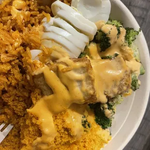 Already started eating whoop. Tofu, egg, jollof, cassava, broccoli, spicy Mayo sauce