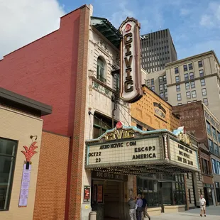 people walking in front of the theater