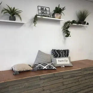 a bench with pillows and plants