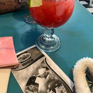 a person sitting at a table with a drink