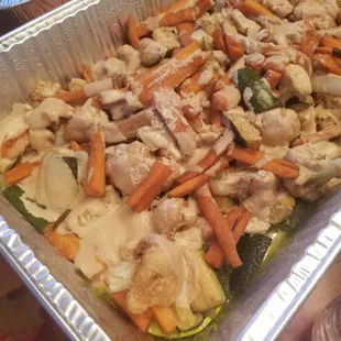Cauliflower, zucchini, and carrots drenched in tahini sauce .