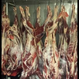 a bunch of meat hanging from a rack