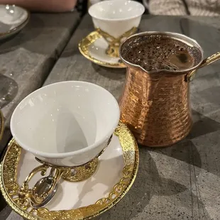a cup of coffee and a saucer on a table