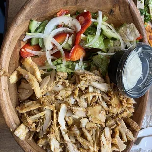 a bowl of chicken salad with dressing