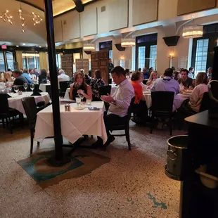 people sitting at tables in a restaurant