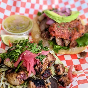 two tacos on a red and white checkered paper