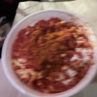 Small esquites with hot cheetos, alot of chilli powder