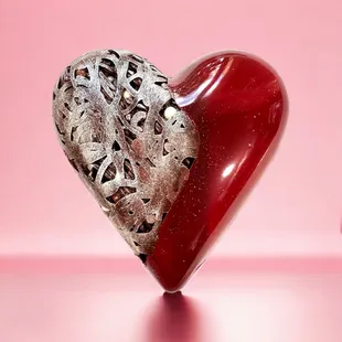 a red heart with a silver design