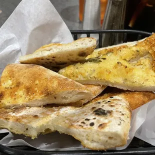 a basket of bread and a drink