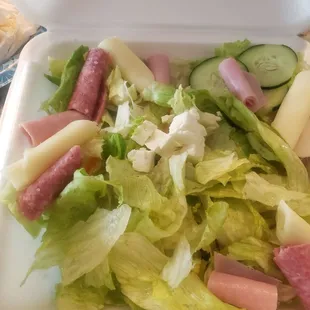 a salad in a styrofoam container