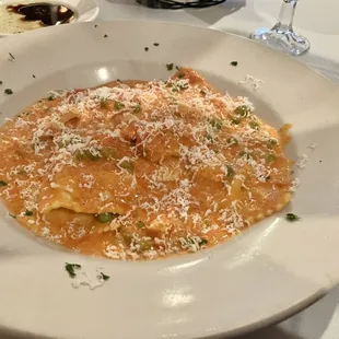 a plate of pasta with peas and parmesan cheese