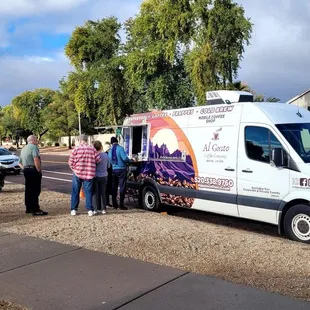 a group of people standing in front of a van