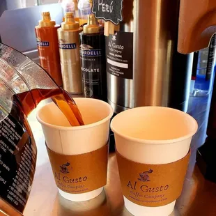 coffee being poured into two cups