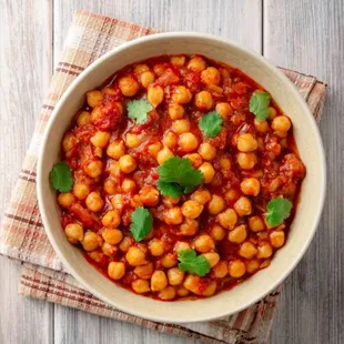 Chana Masala Delight: A delectable vegetarian dish featuring chickpeas simmered in a rich blend of aromatic spices, creating a flavorful.