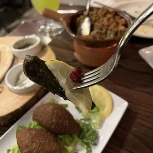 Heaven bite (grape leaves, lemon slice, pomegranate seed)