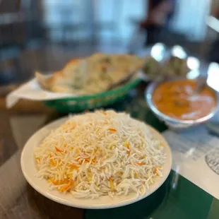 a plate of rice and a bowl of soup