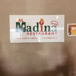 a sign for al madina restaurant
