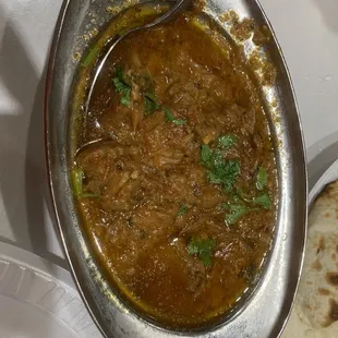 a bowl of stew with a spoon in it
