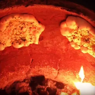 Garlic Naan made to order in the tandoor oven using fresh charcoal everyday!!
