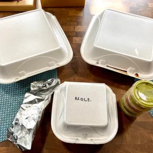 three takeout containers on a table