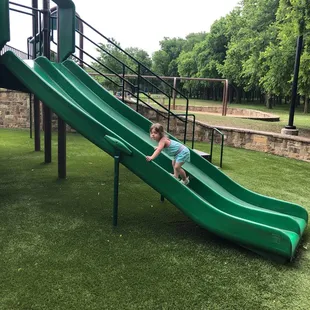 Addison climbing a slide
