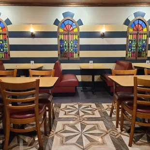 a dining area with stained glass windows