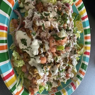 Spicy chicken shawarma over salad bursts with flavor!